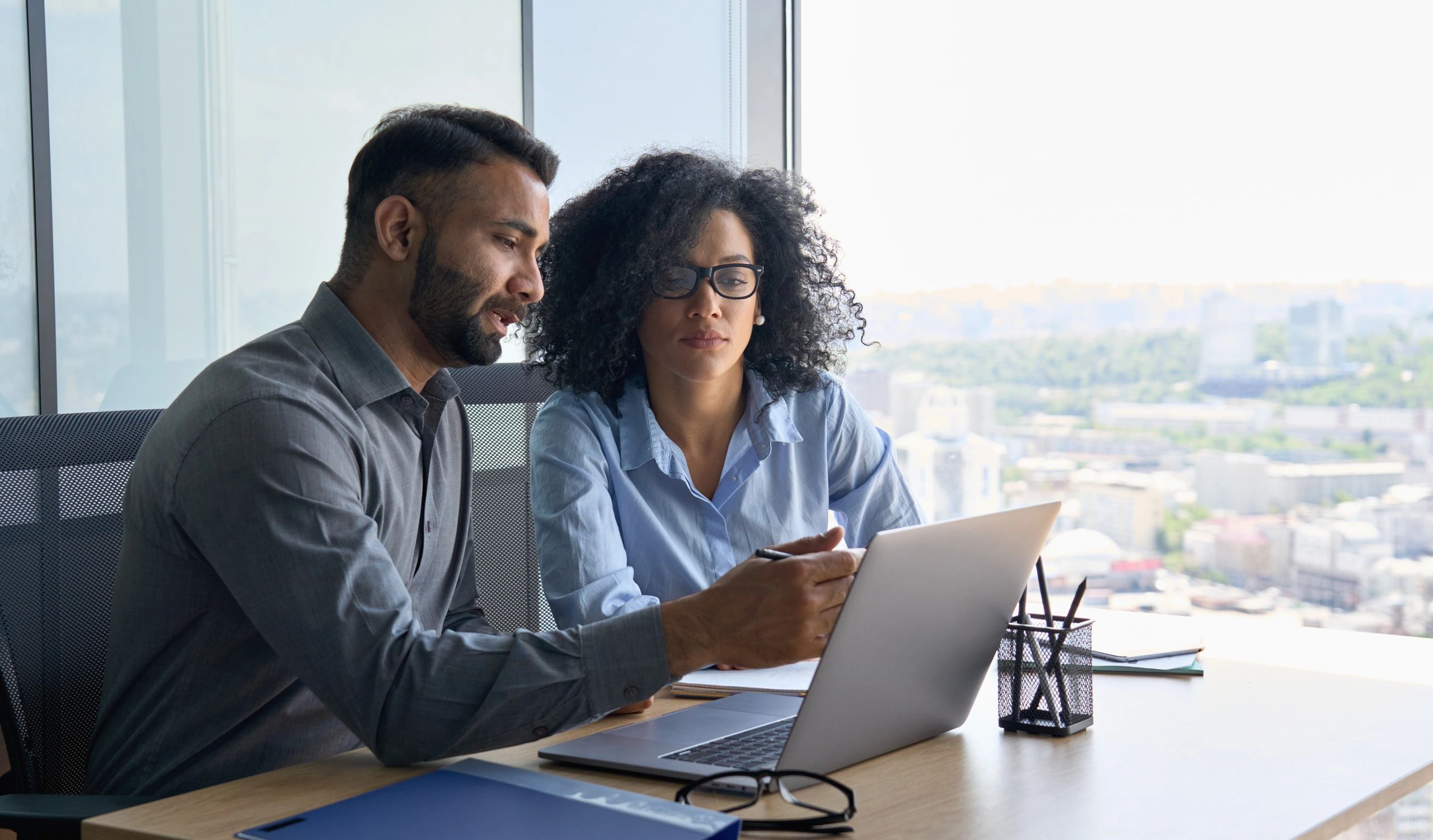 Two professionals collaborating in a modern office